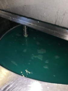Picture from the Jake Wastewater Line at BBEU facilities in Belgium showing turquoise liquid in a steel vessel